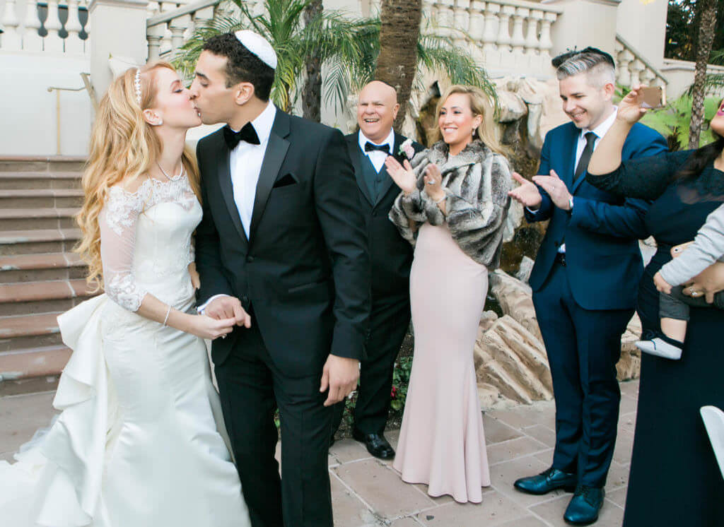 Bride and groom kissing after first look 