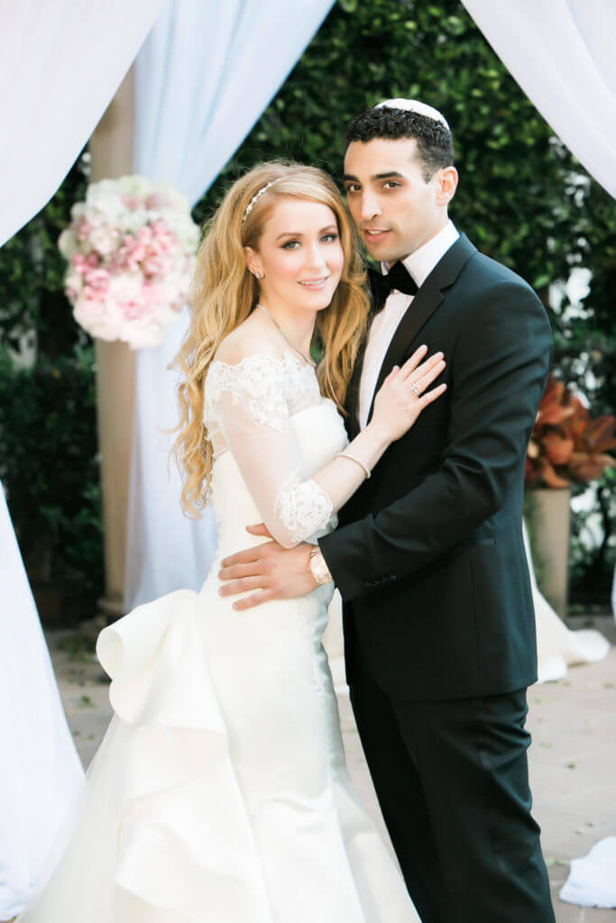 Bride and groom holding each other 