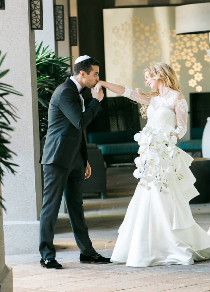 groom kissing brides hand 