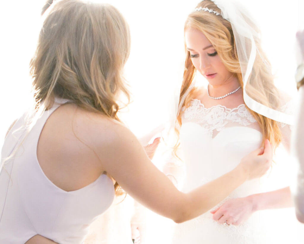 Bride looking down wearing a shot veil