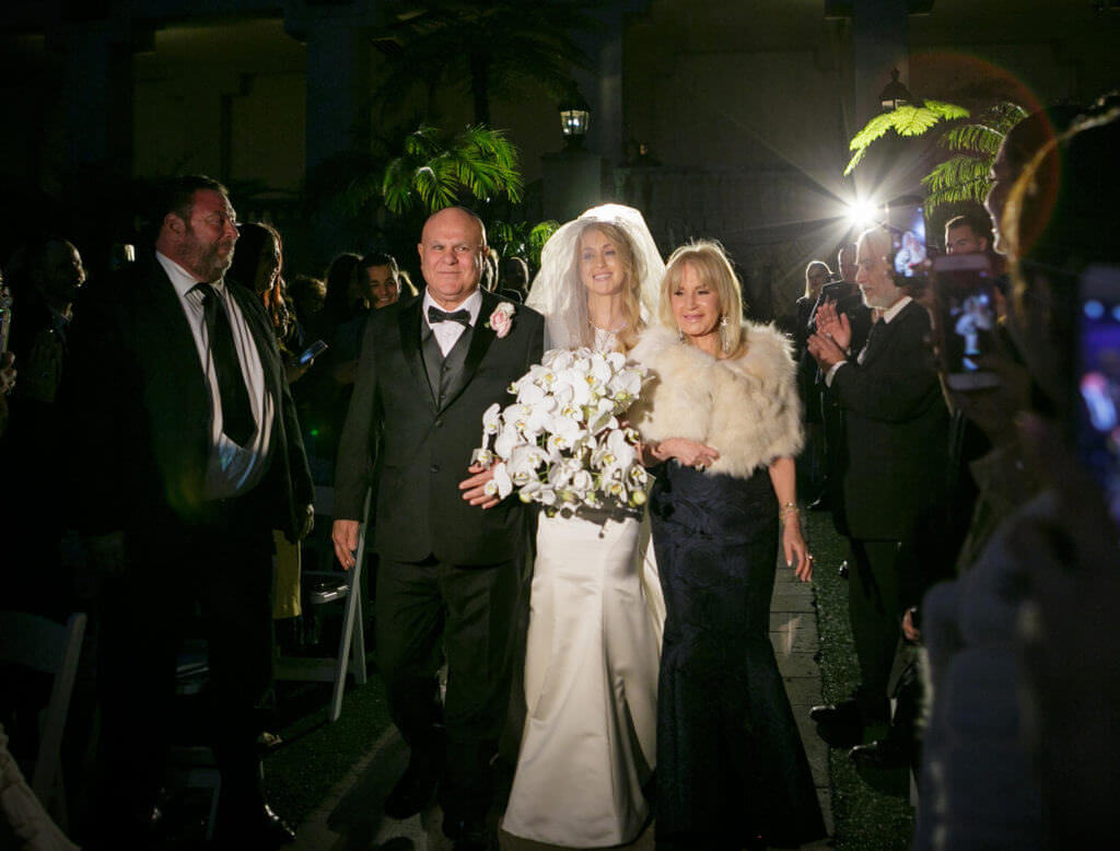 Bride walking down the Isle with parents 