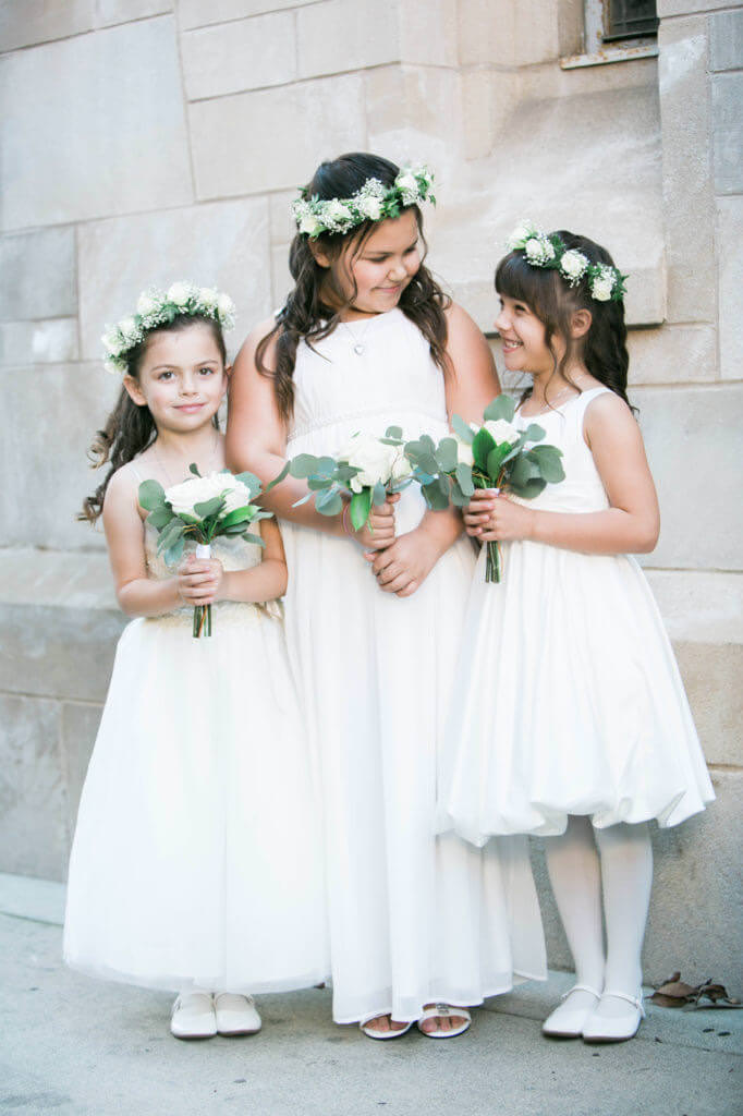 flowers girls wearing a tiara of white roses at St Monic'as church 