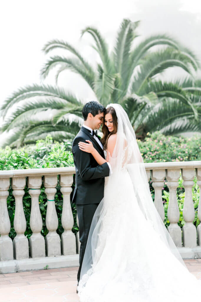 Husband and wife hugging gently at the balcony of Bel Air Bay Club 