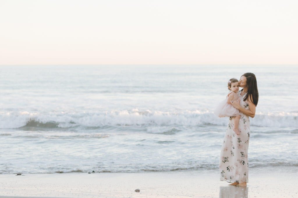 Mom featuring little daughter kissing 