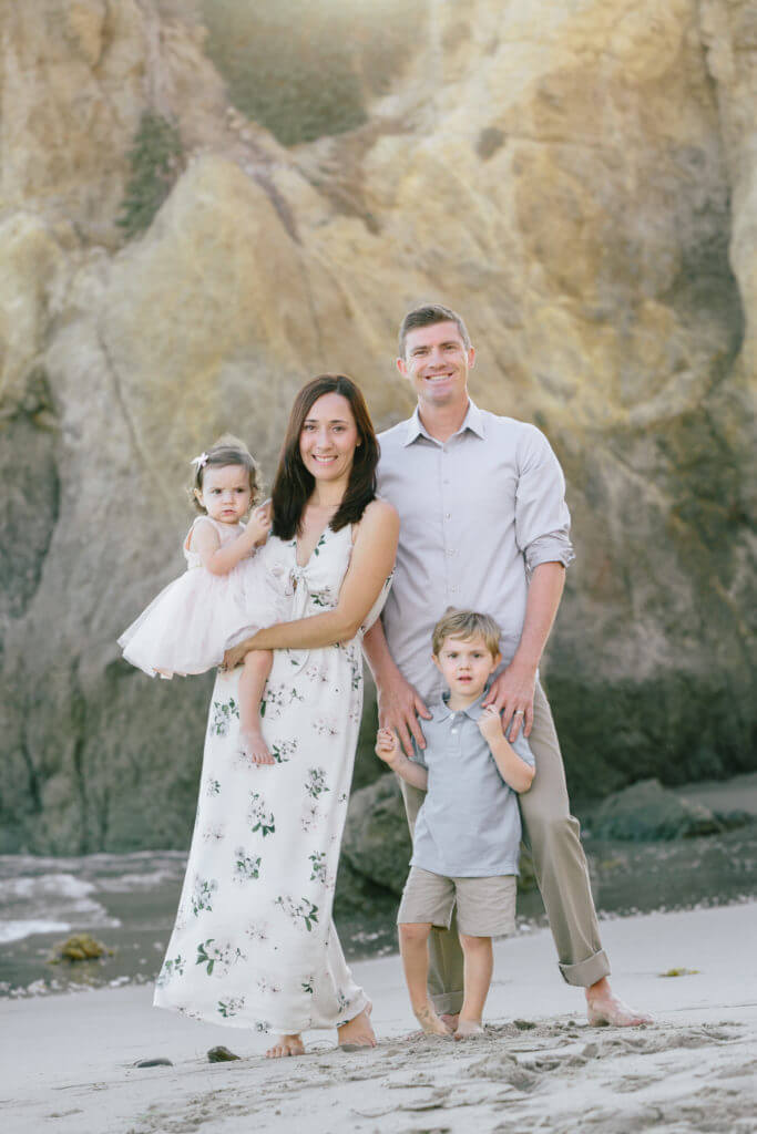 Family standing on the beach 