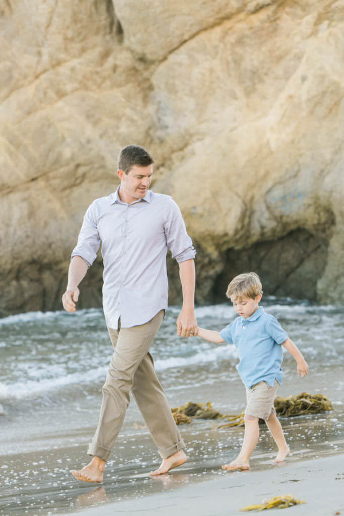 Dad and son walking wearing pastel tones 