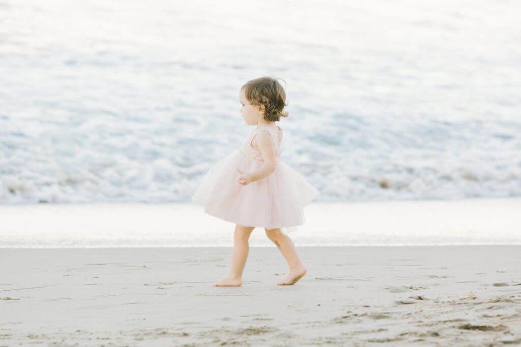 Lili walking solo at the beach wearing pink tutu 