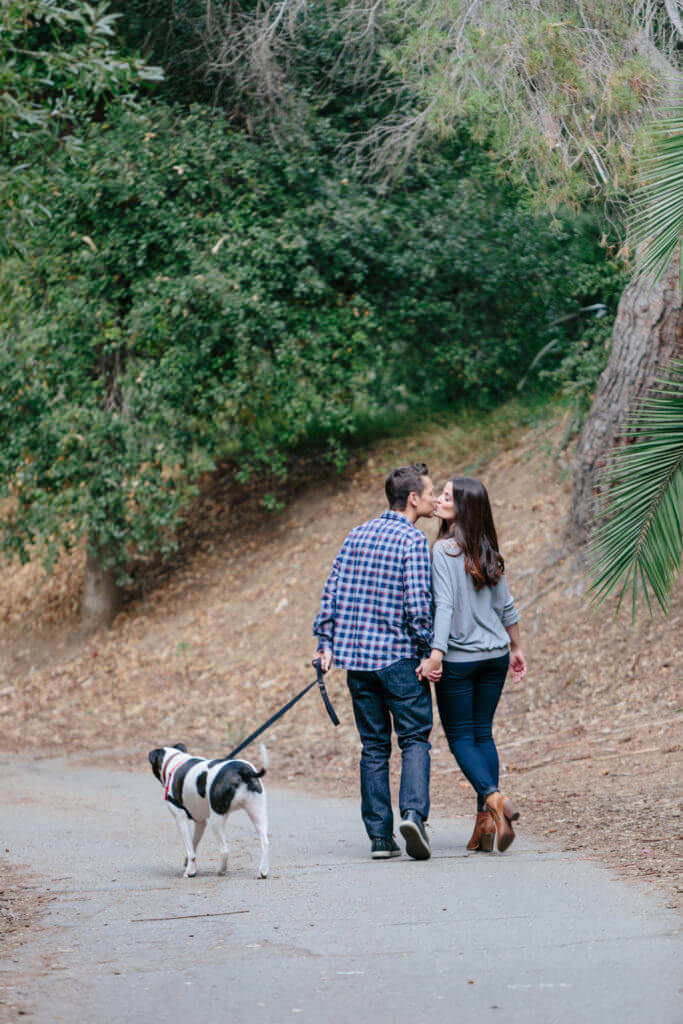 engagement session couple walking with a dog 