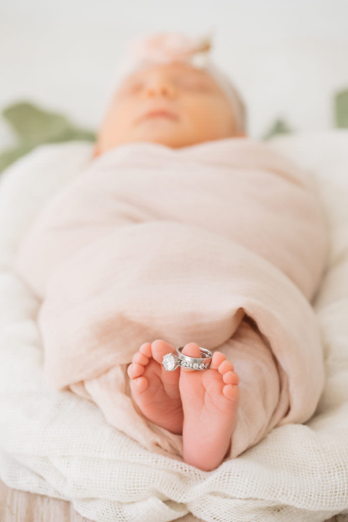 Baby feet with diamond ring on their feet