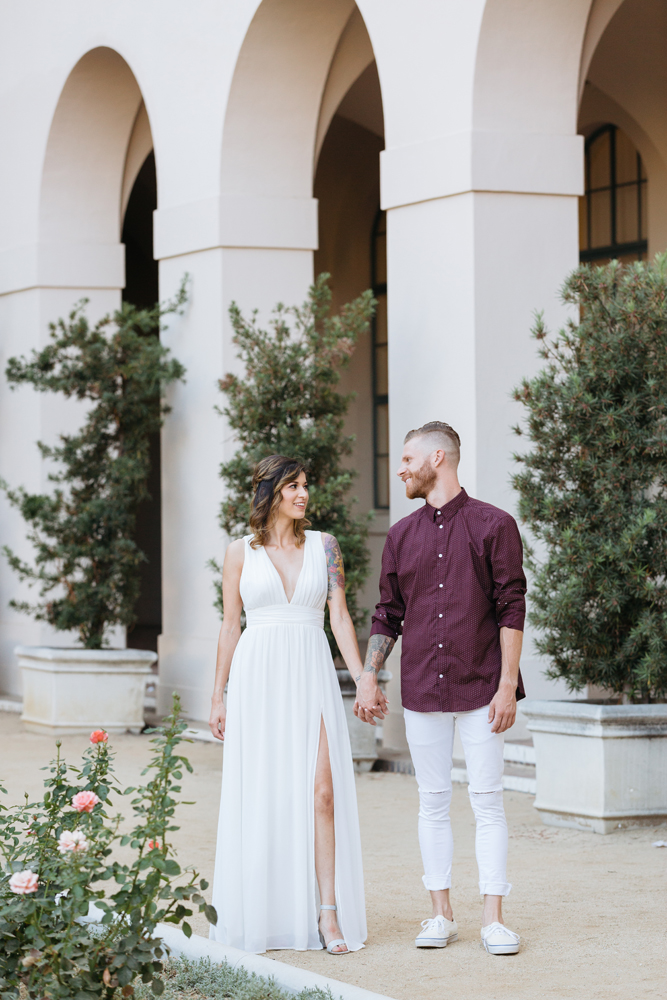 Couple holing hands and walking at the Pasadena City Hall 