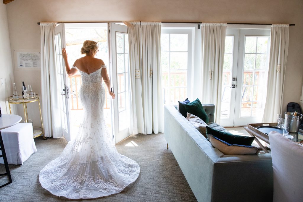 Bride wearing a wedding dress showcasing the back of her dress in Calamigos Ranch
