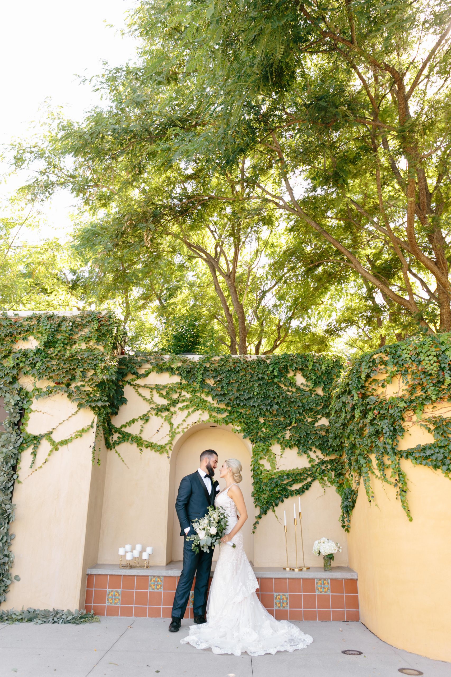 bride and groom standing at Los Robles green