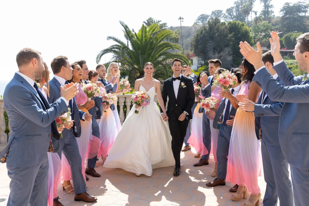 Couple walking on the middle of their bridal party at Bel Air Bay Club