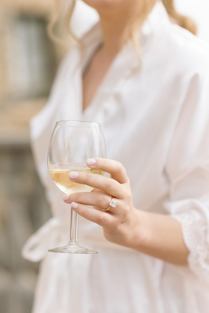 Bride holding a glass of wine