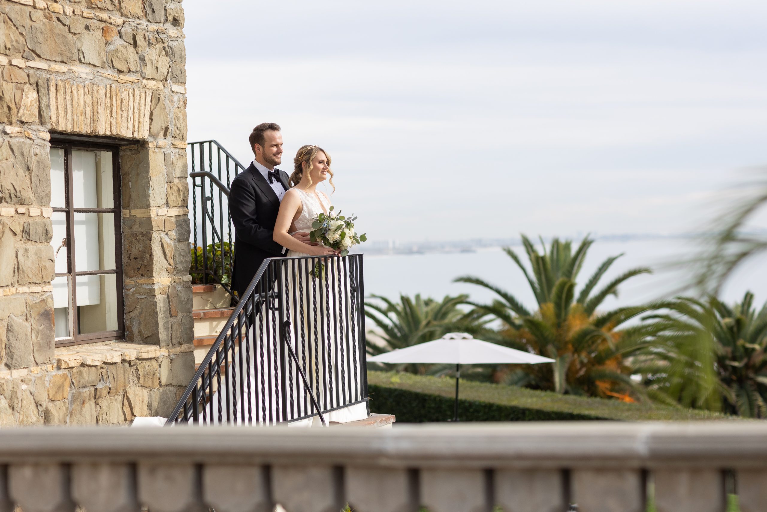 Couple on the balcony at Bel Air Bay Club over looking the Pacific Ocean