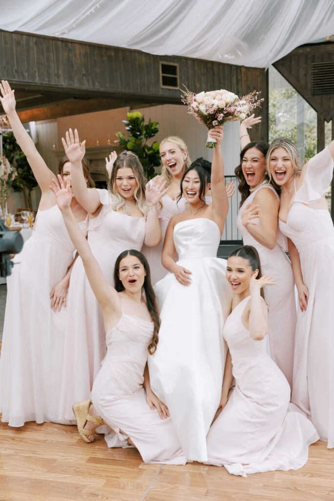 Bridesmaids holding a pink bridal bouquet at Calamigos Ranch