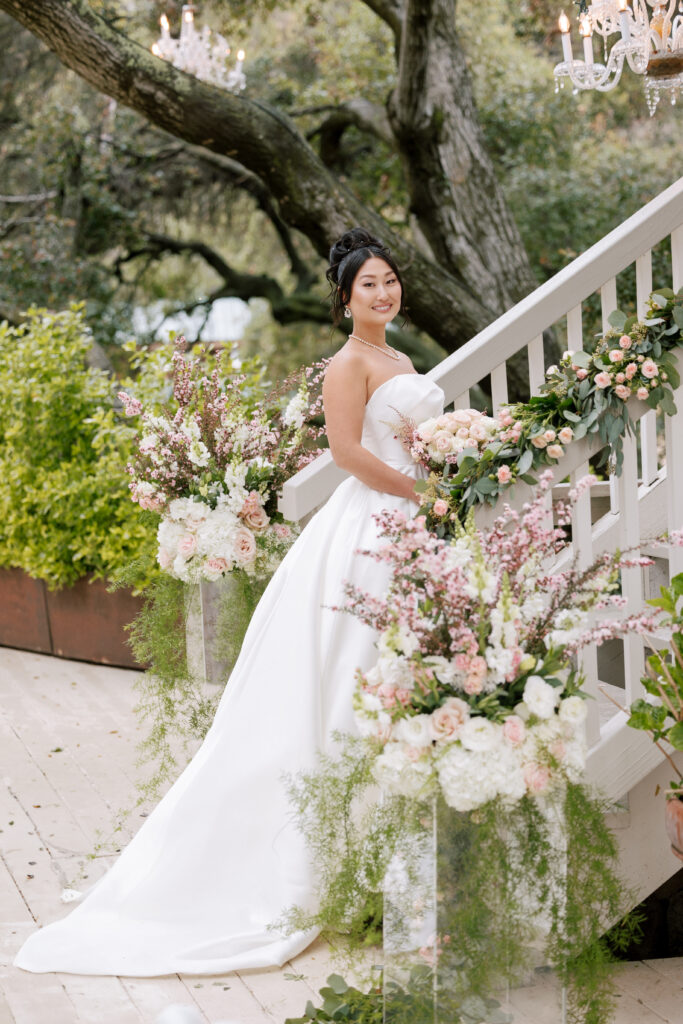 Bride standing at the outdoor stairs at the Oak Room in Calamigos Ranch 