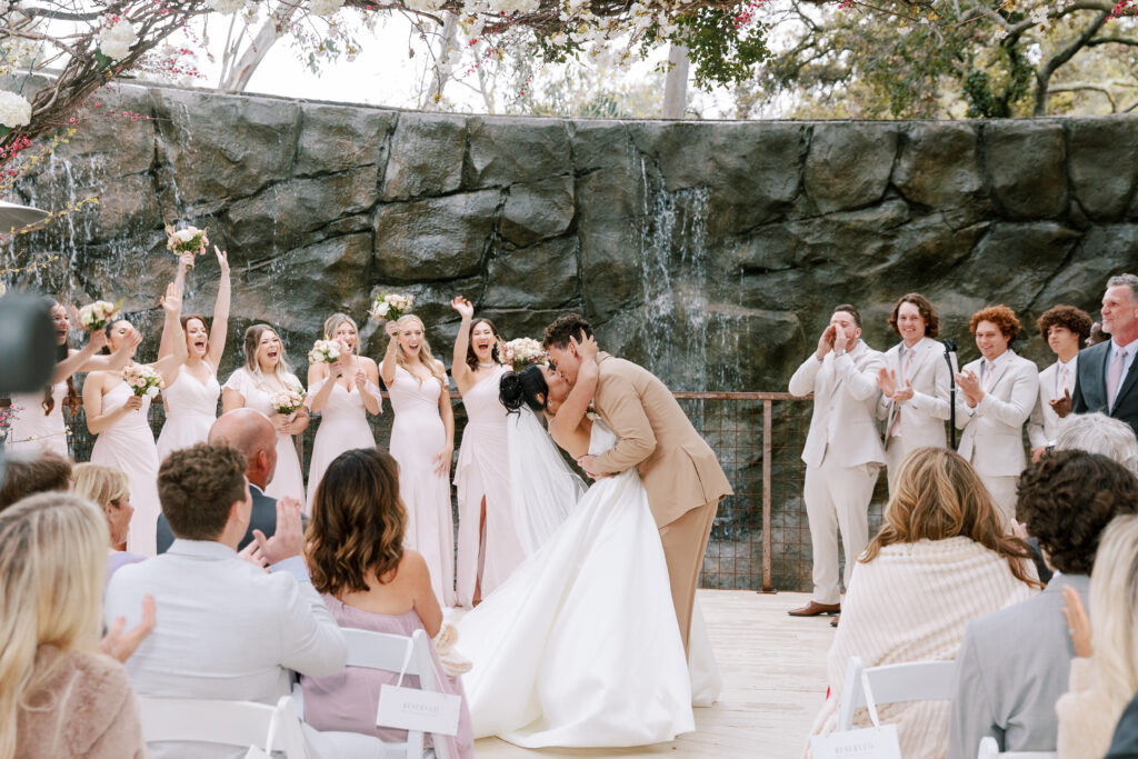 Bride and groom kissing at ceremony site at Calamigos Ranch