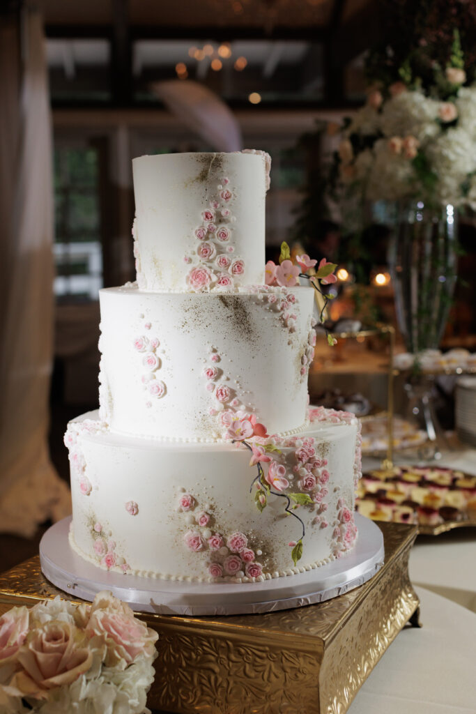 White three tier cake with pink flowers 