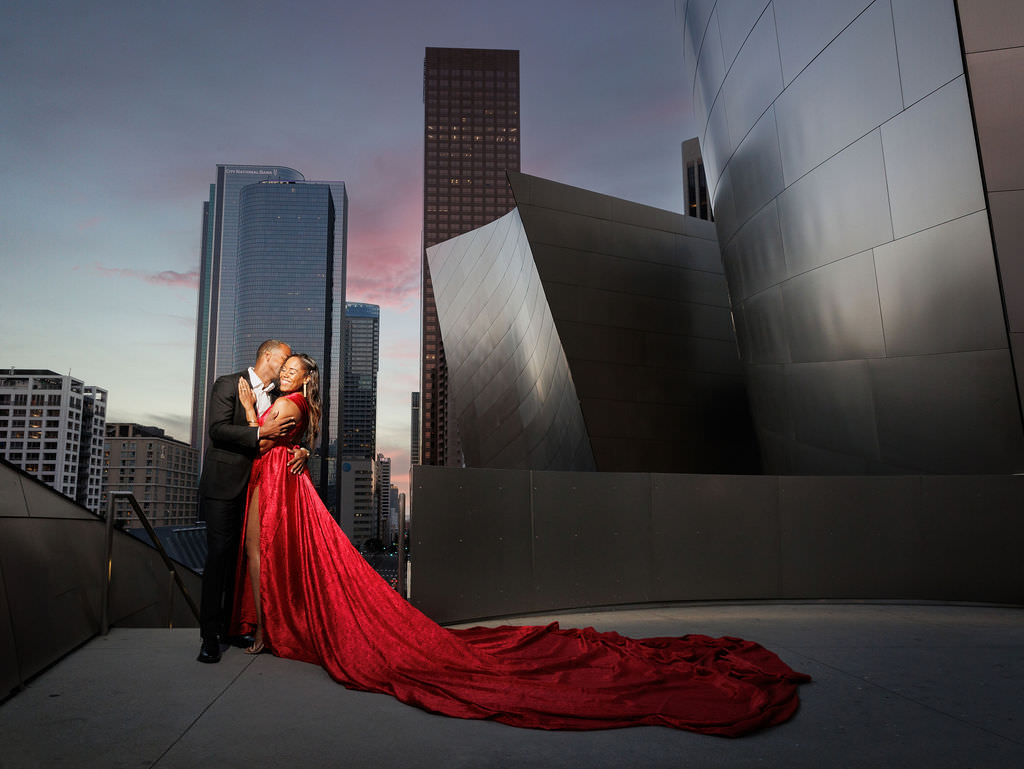 Disney Concert Hall during an engagement session couple wearing formal weardrove