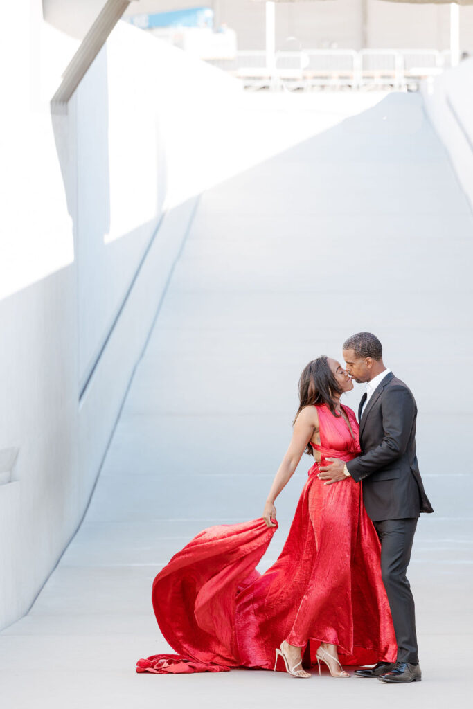 Couple at MOCA museum female wearing a red dress and male a formal gray suit