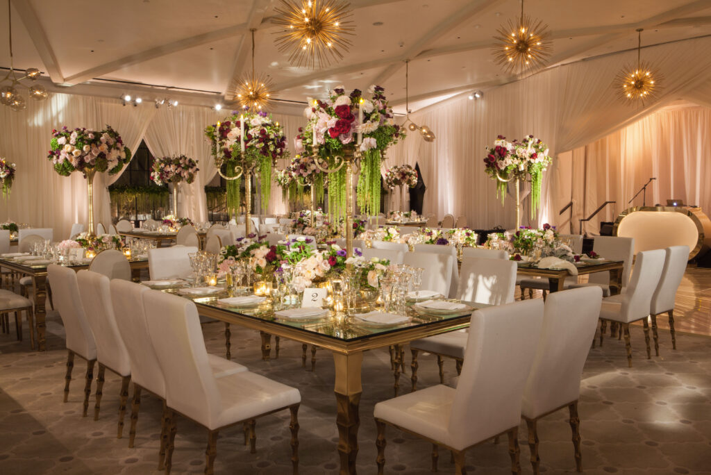 Reception room at hotel Bel-Air with white chairs and rose gold dinner tables 