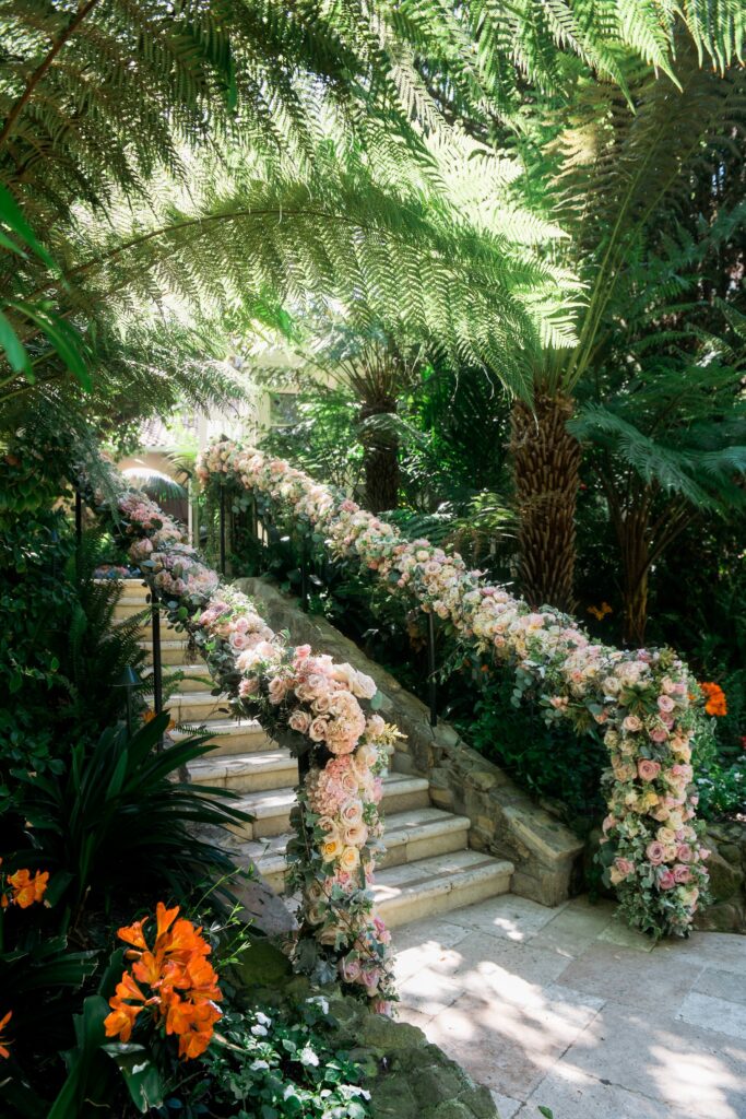 Steps with a hand rail  with filled with pink roses at hotel Bel-Air