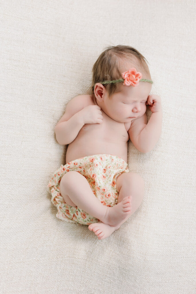 Newborn baby wearing a pink flower