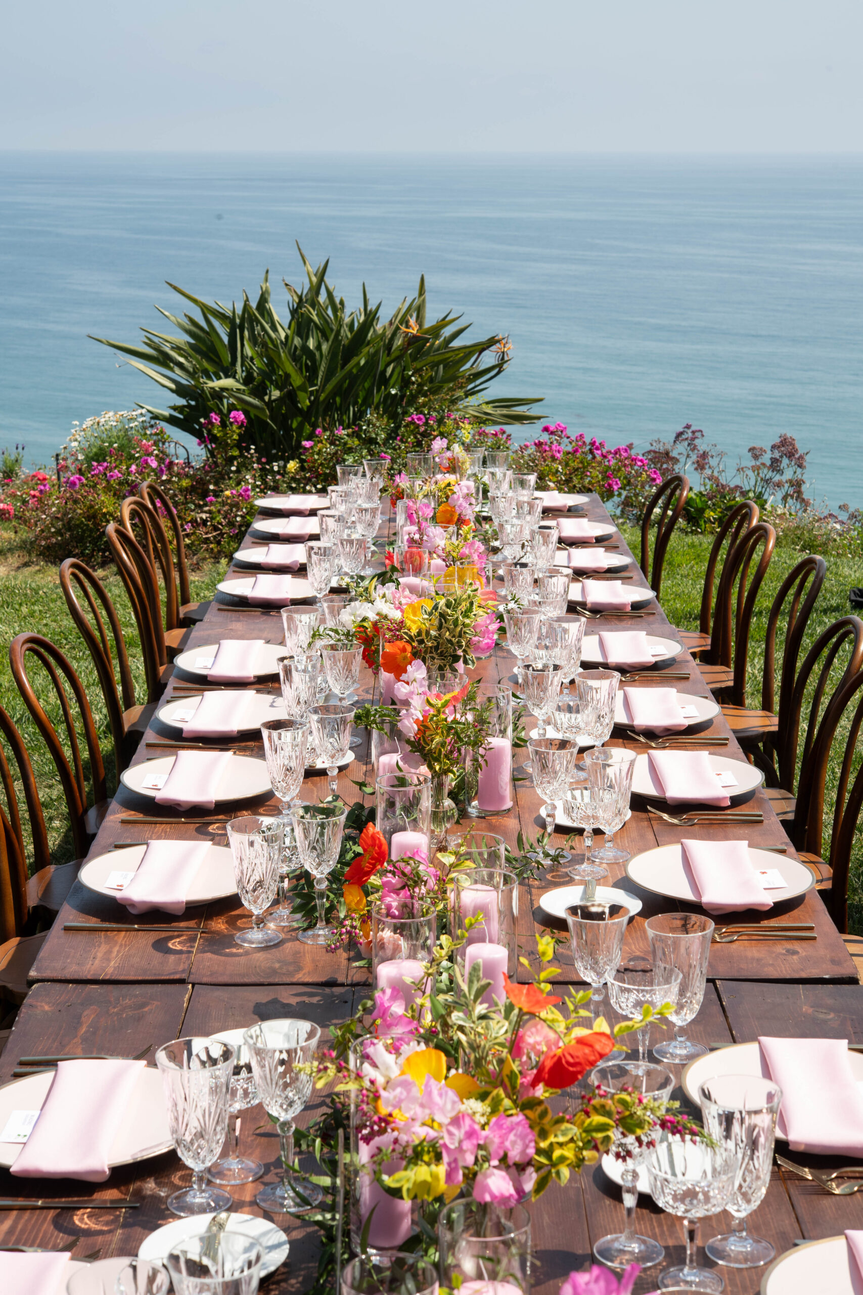 Long wooden table with pink flowers