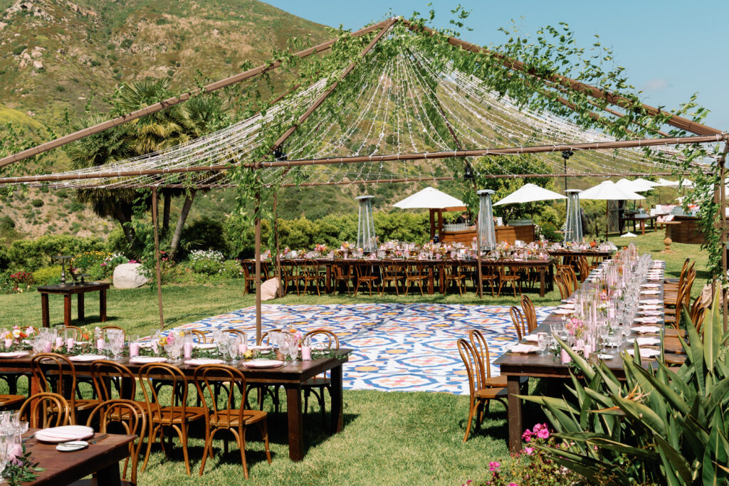 Wedding set up for guest to have dinner wooden tabes with bright center pieces