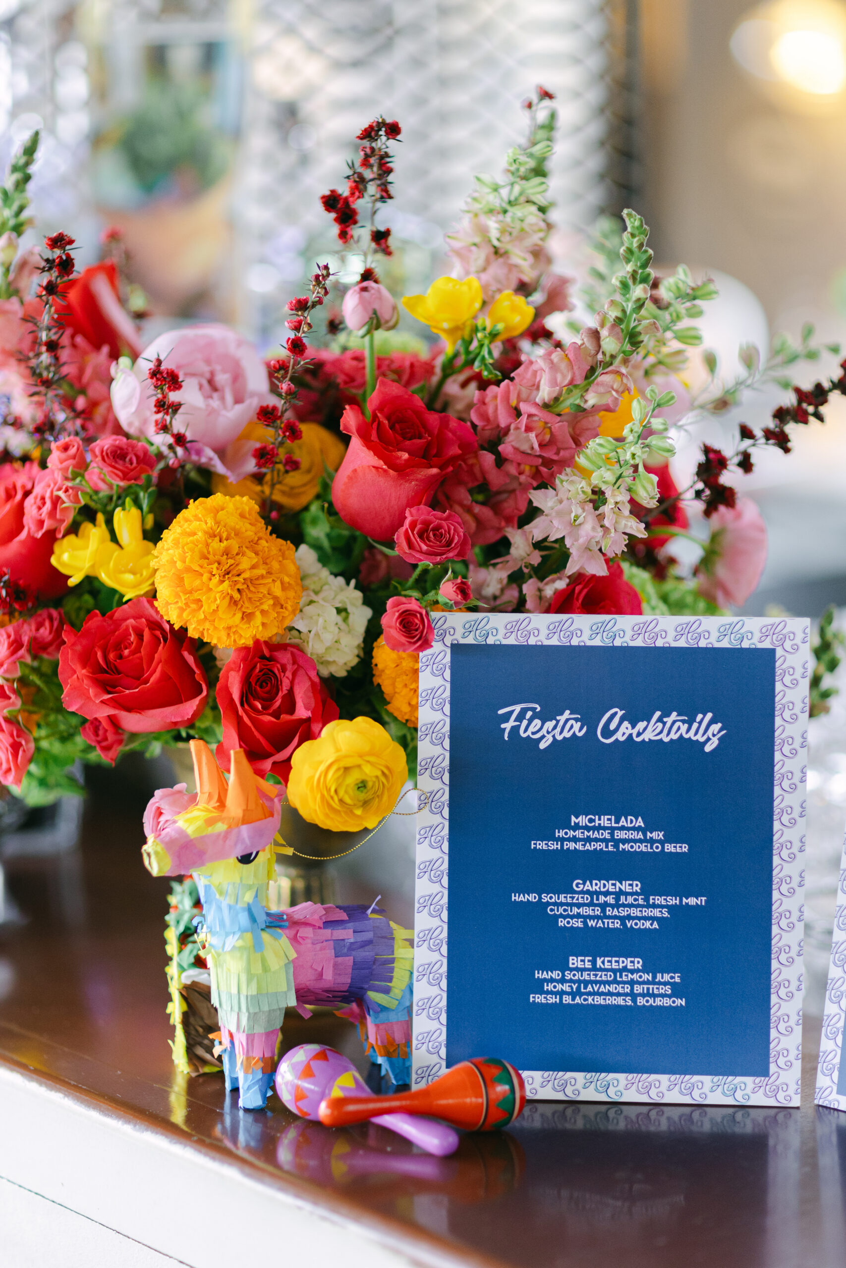 Menu for a fiesta display next to some mini pinatas