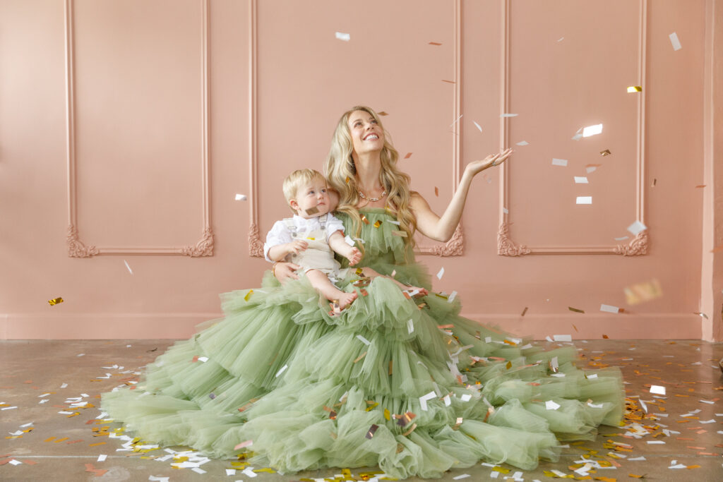Mother and baby sharing a playful moment during an elegant studio family session