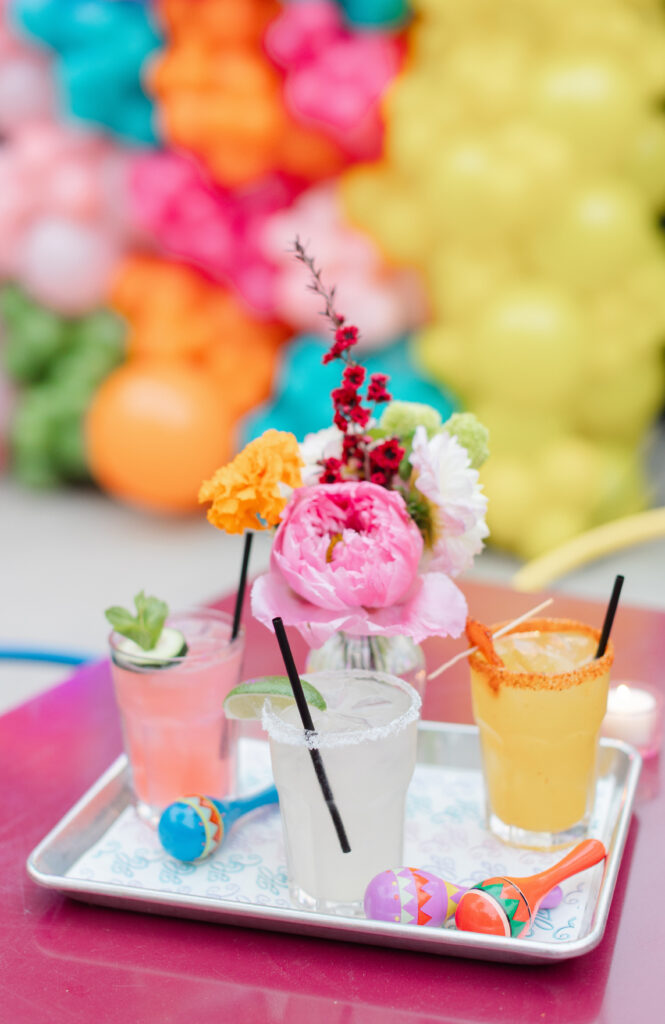 Colorful fiesta cocktails, maracas, and fresh flowers arranged for the Bat Mitzvah pre-party