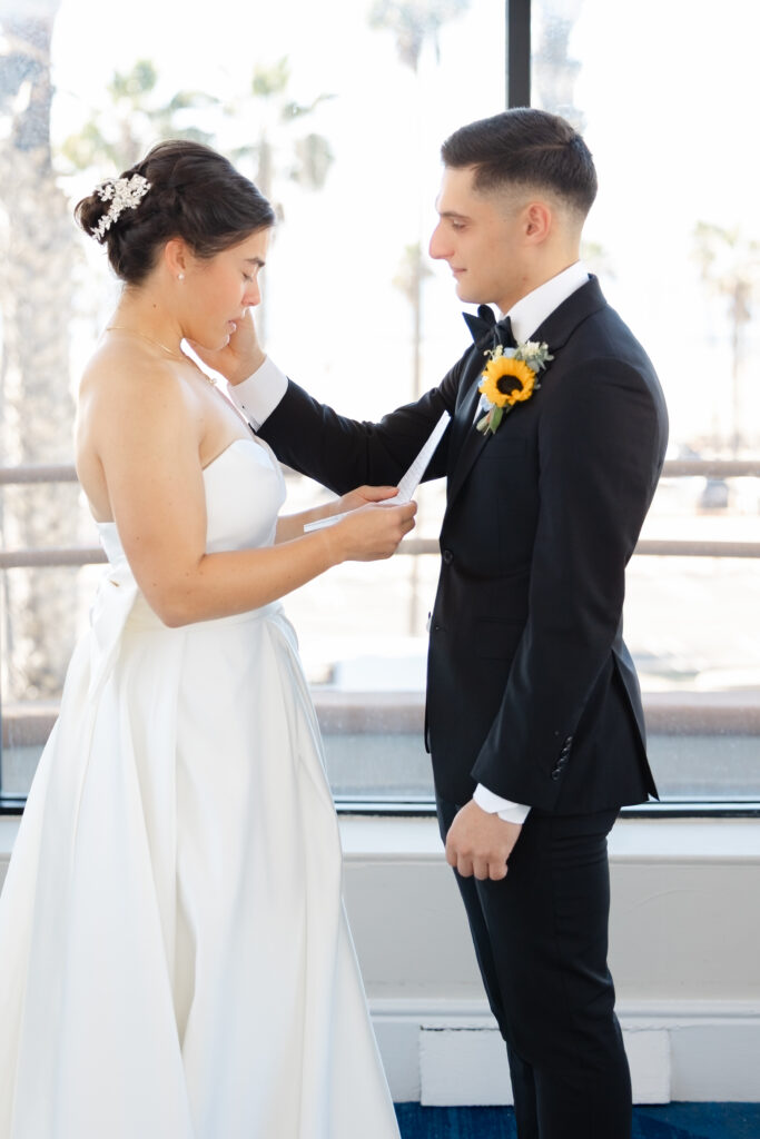 Emotional bride and groom sharing a quiet first-look moment before their Huntington Beach wedding