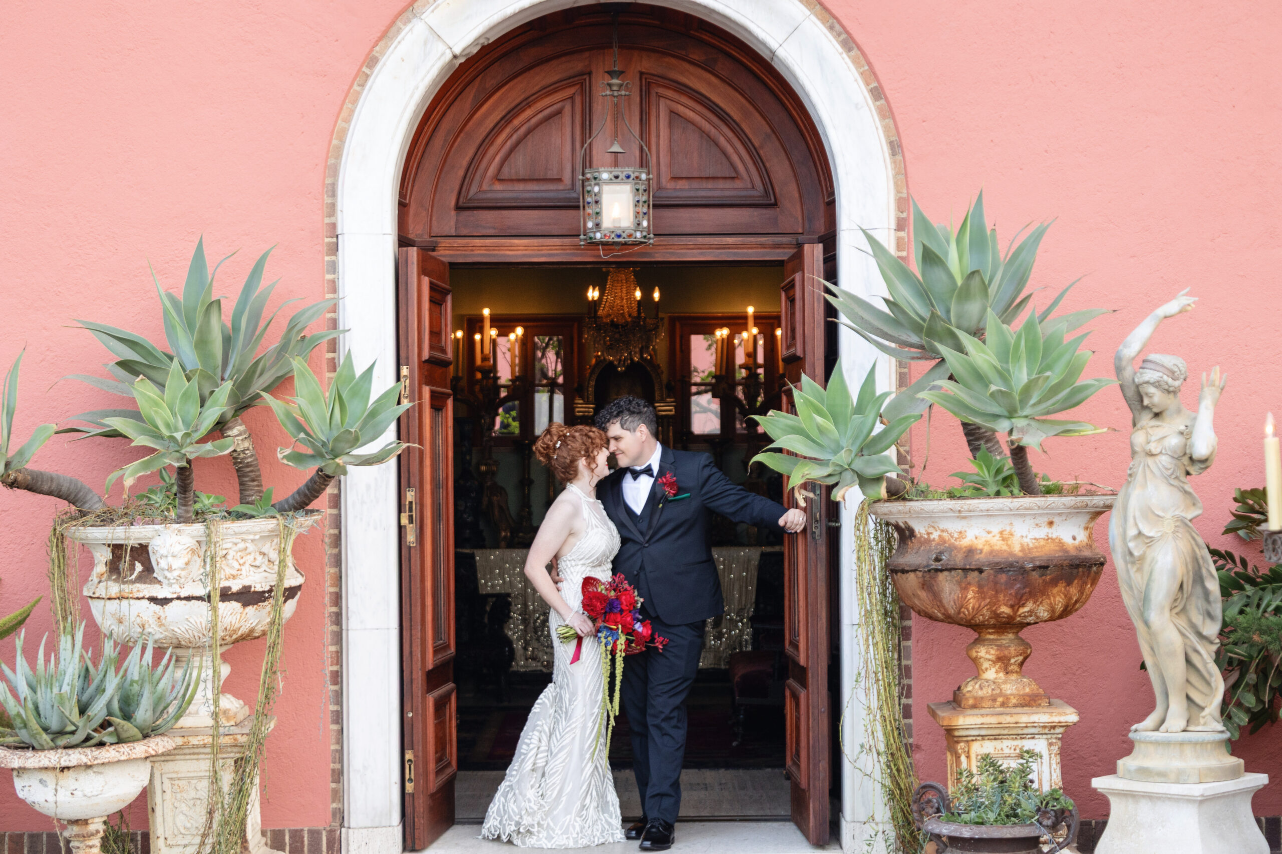 Newlyweds standing together in the arched entrance of Paramour Estate in Los Angeles.