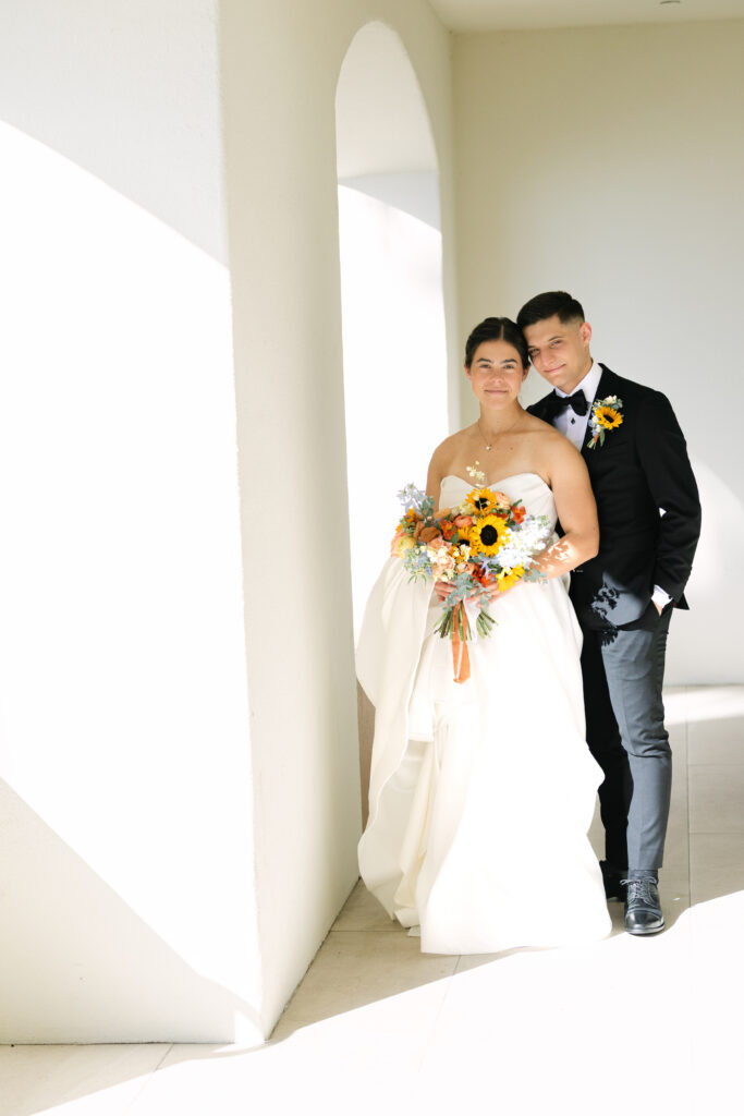 Elegant bride and groom portrait surrounded by modern white architecture and natural California light.